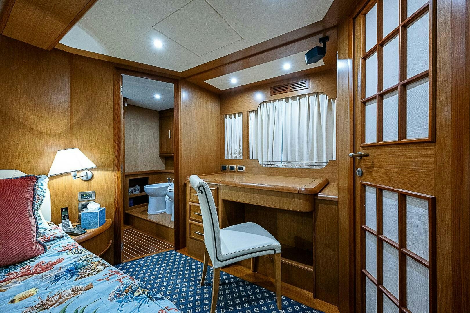a bedroom with a bed and a desk aboard KNOT NANNY'S Yacht for Sale
