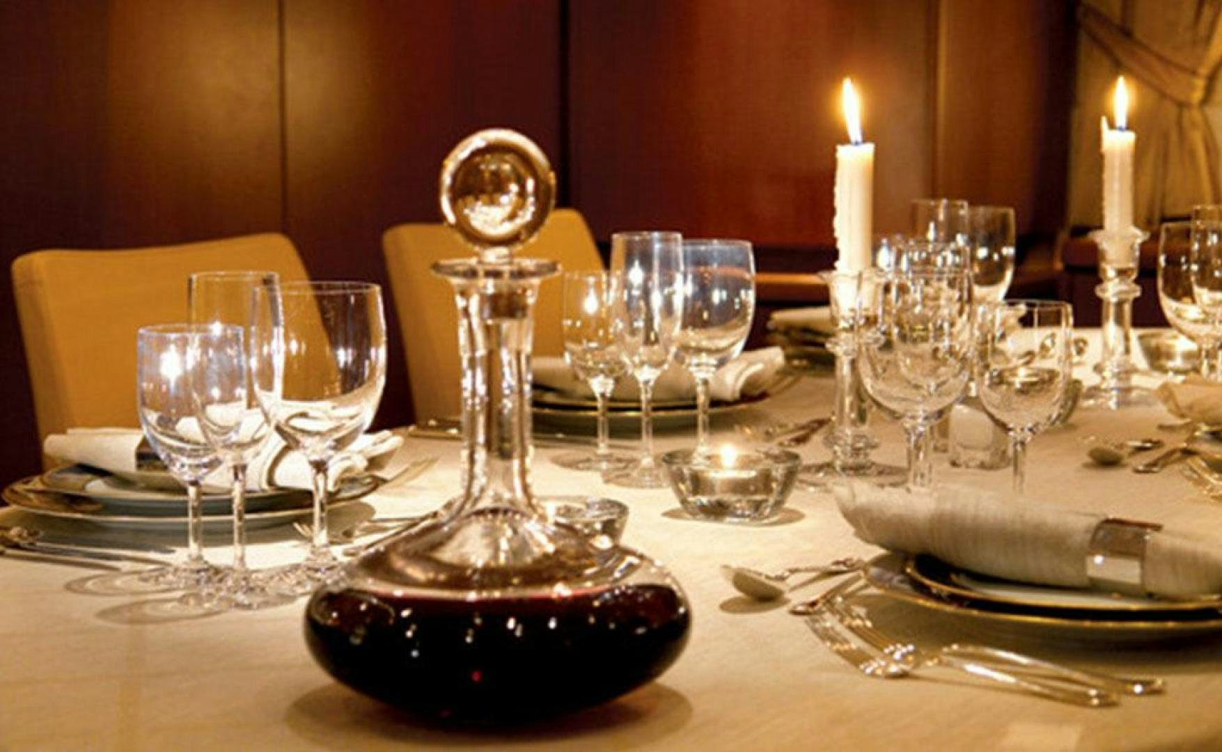a table with wine glasses and plates aboard ARISTARCHOS Yacht for Charter