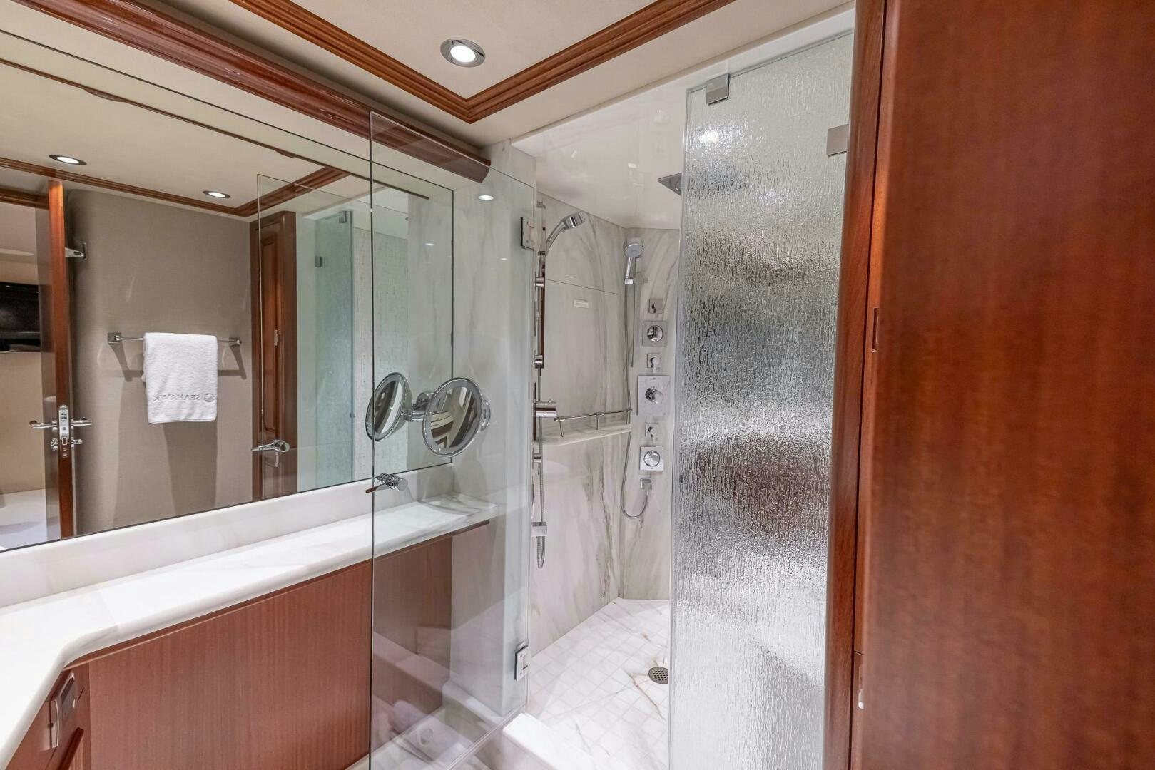 a bathroom with a glass shower aboard SEAHAWK Yacht for Sale