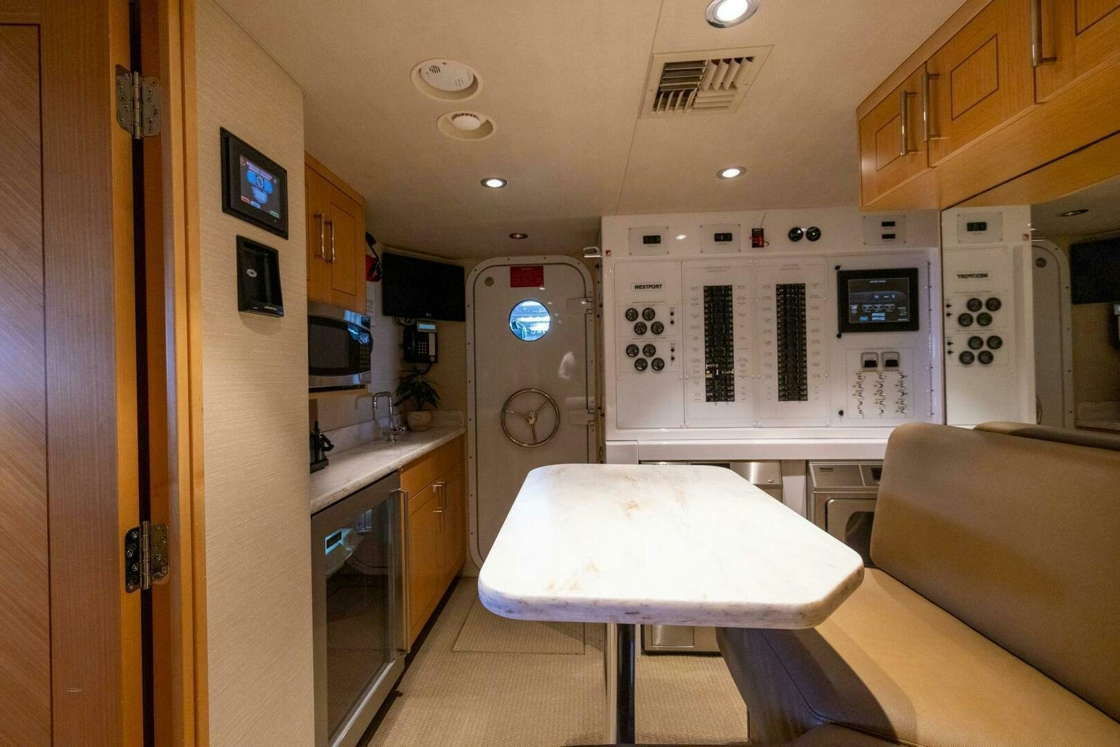 a kitchen with a table and a couch aboard SEAHAWK Yacht for Sale