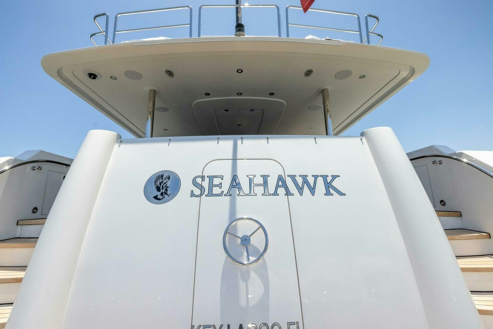a white boat with a blue sign aboard SEAHAWK Yacht for Sale