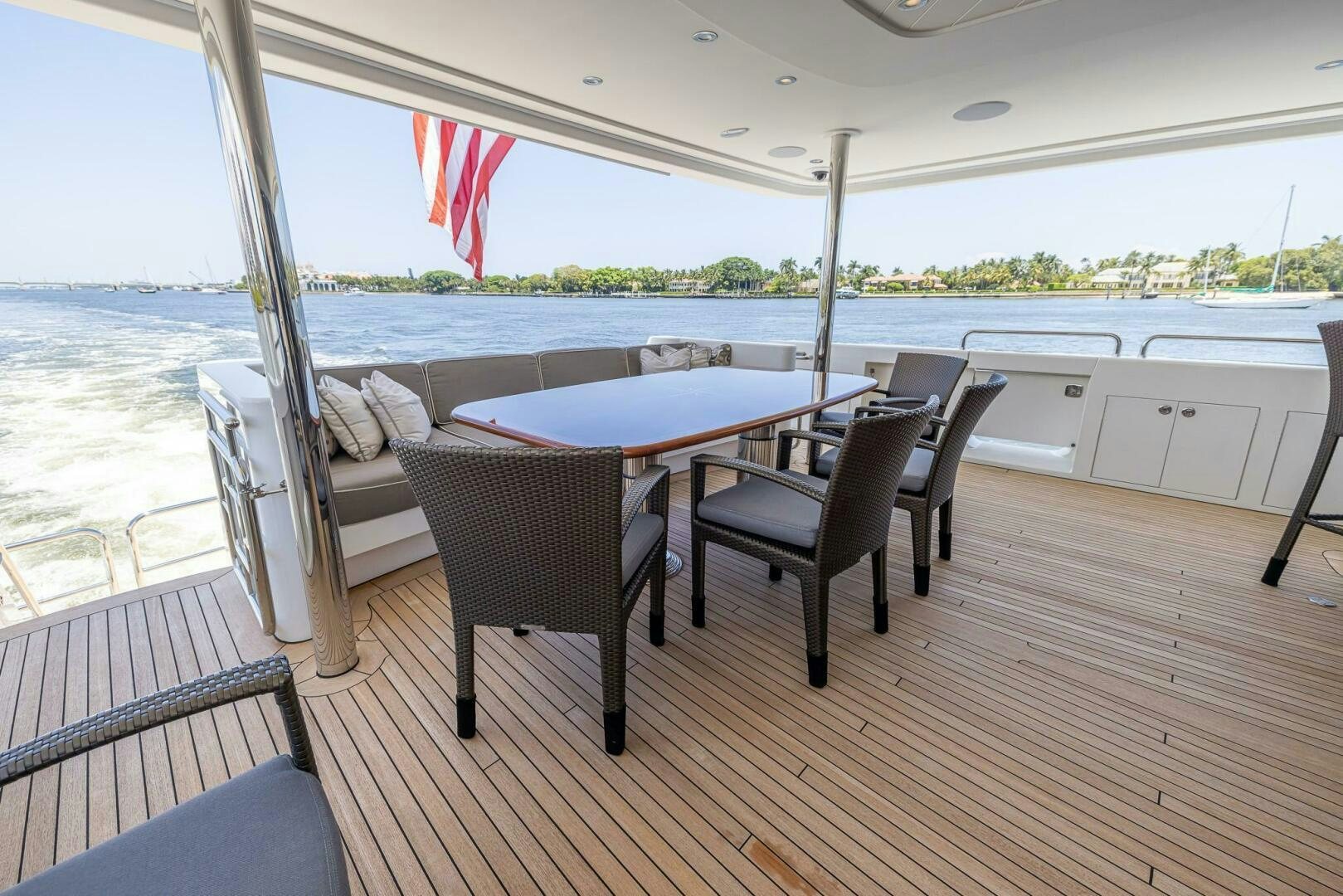 a deck with a table and chairs aboard SEAHAWK Yacht for Sale
