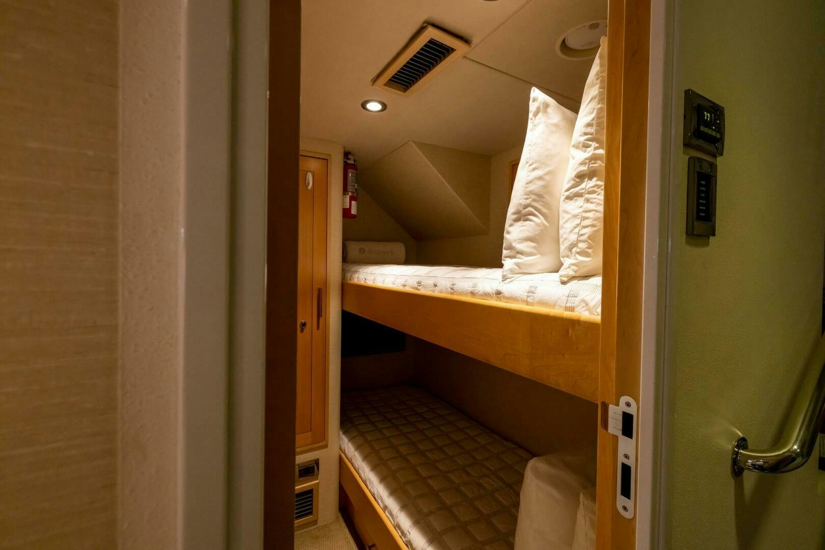 a room with a bed and a door aboard SEAHAWK Yacht for Sale