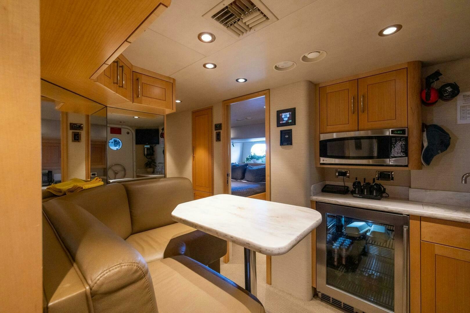 a kitchen with a table and a couch aboard SEAHAWK Yacht for Sale