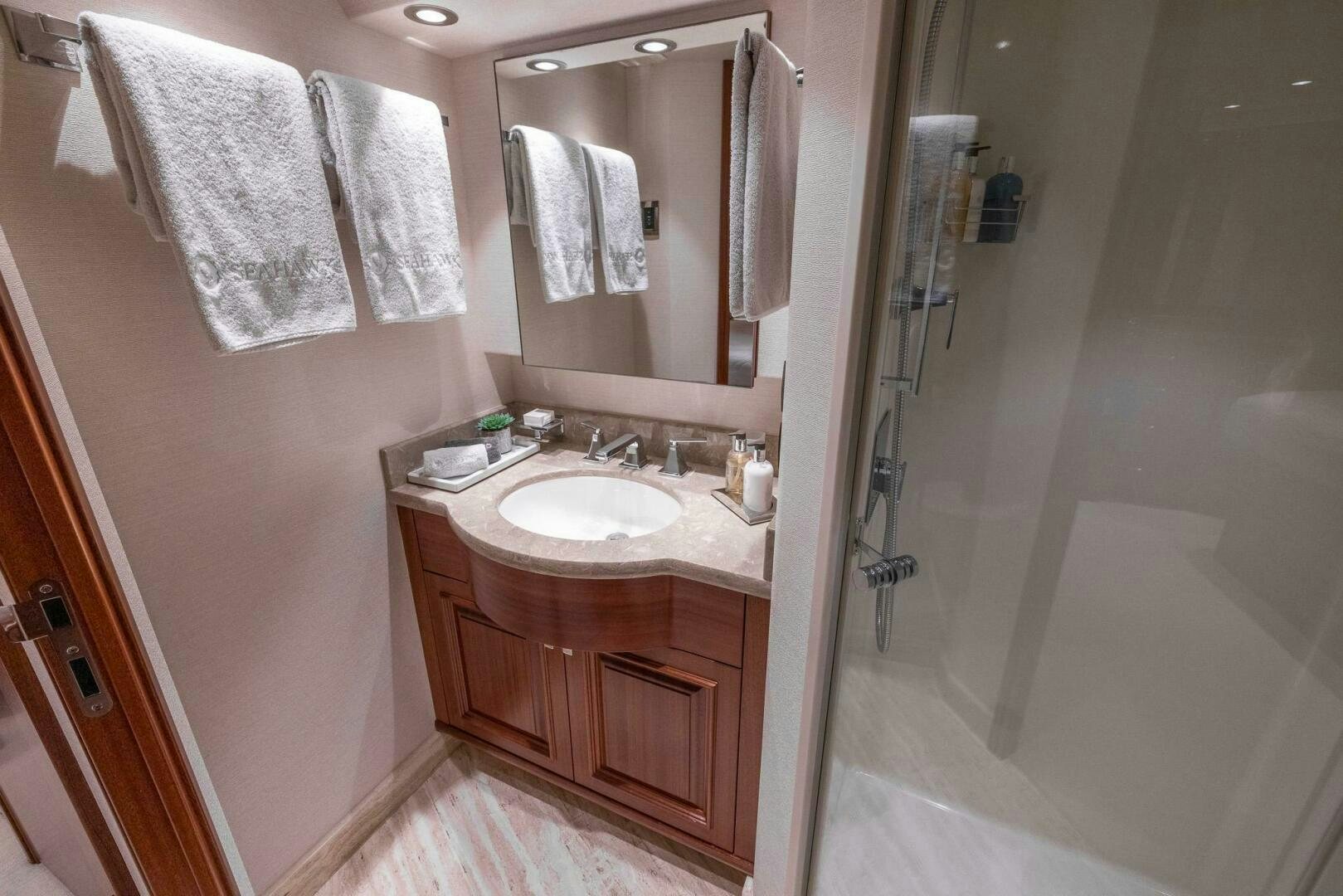 a bathroom with a sink and a shower aboard SEAHAWK Yacht for Sale