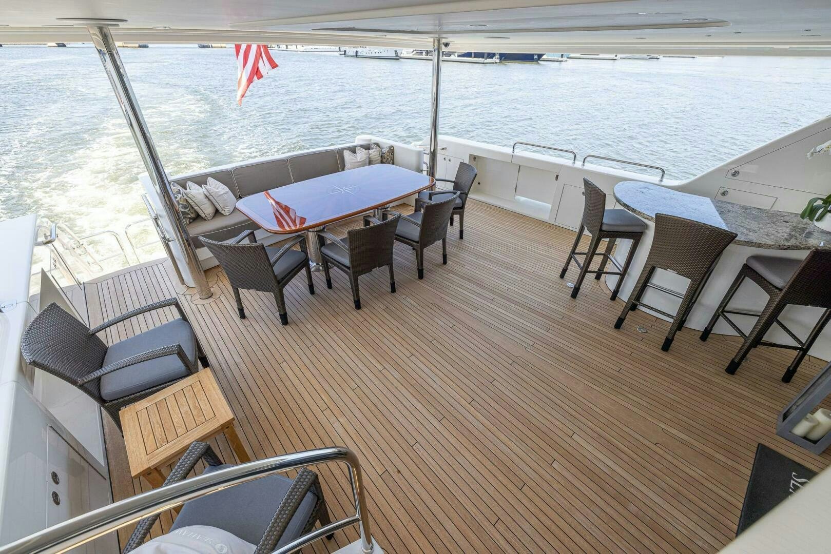 a deck with a table and chairs aboard SEAHAWK Yacht for Sale