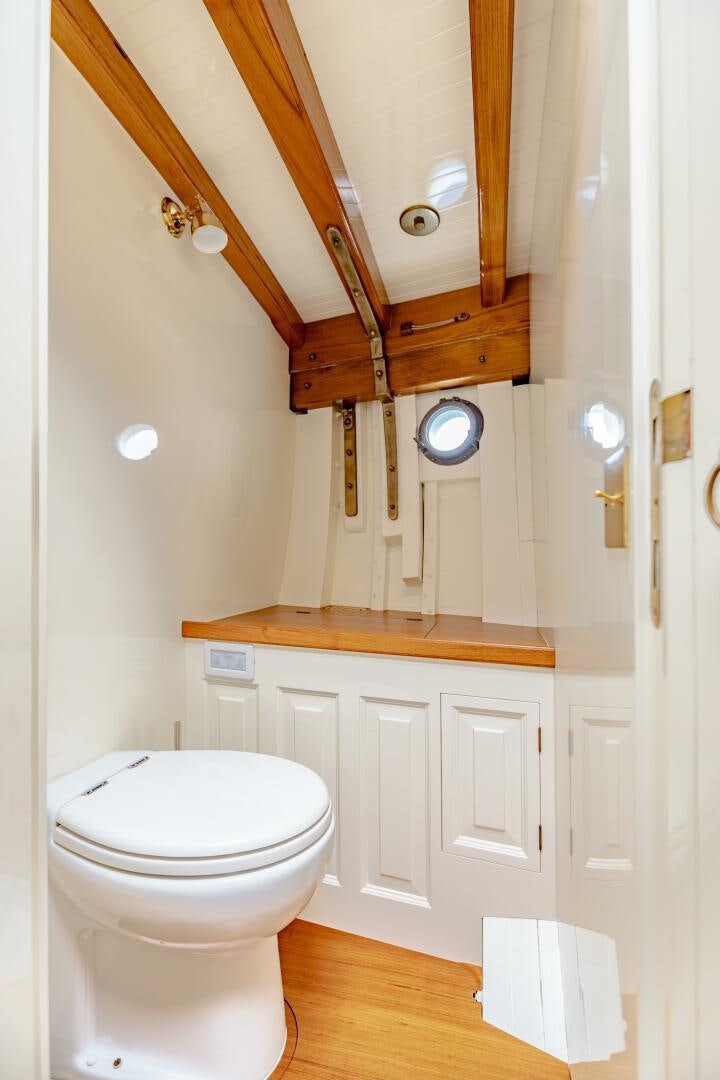 a toilet with wooden ceiling aboard ARMIDE Yacht for Sale