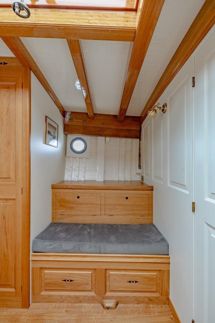 a wooden bunk bed in a room aboard ARMIDE Yacht for Sale