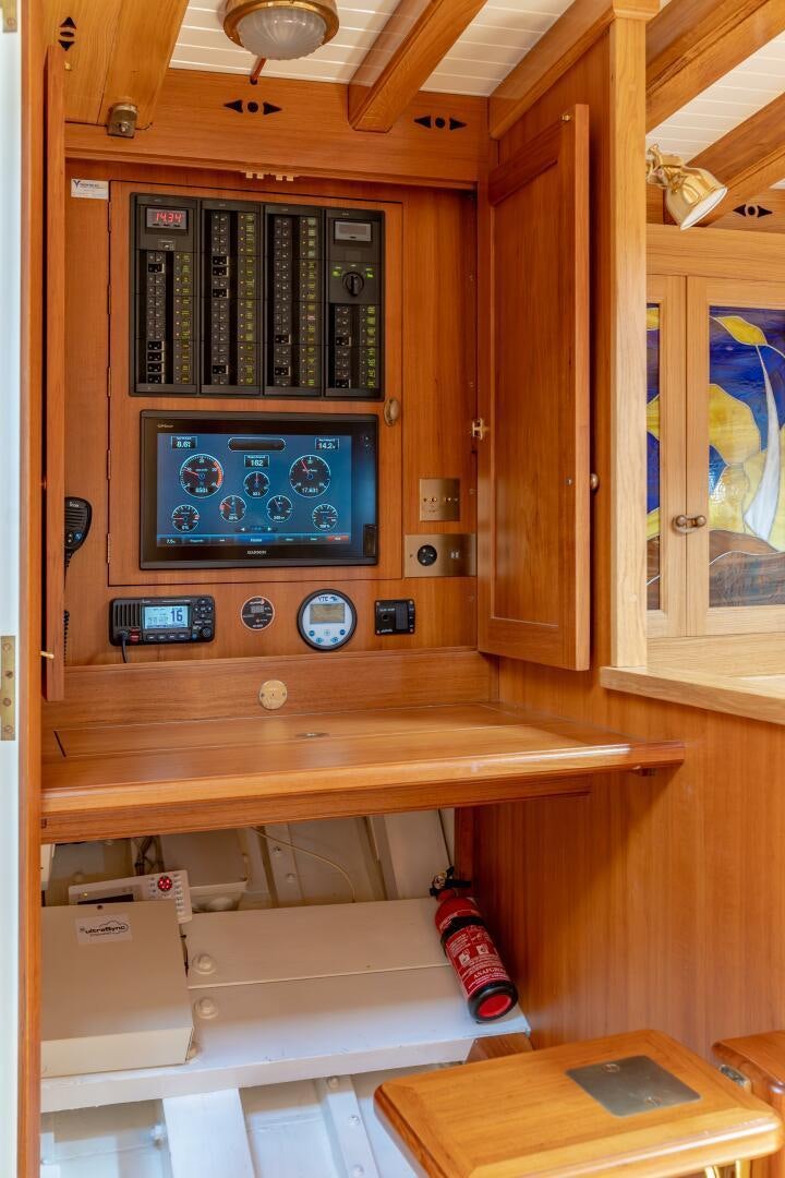 a wooden cabinet with a computer and a desk aboard ARMIDE Yacht for Sale