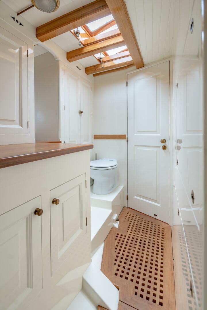 a small bathroom with white cabinets aboard ARMIDE Yacht for Sale