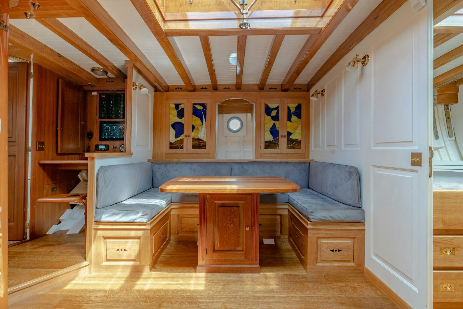 a living room with a table and couch aboard ARMIDE Yacht for Sale