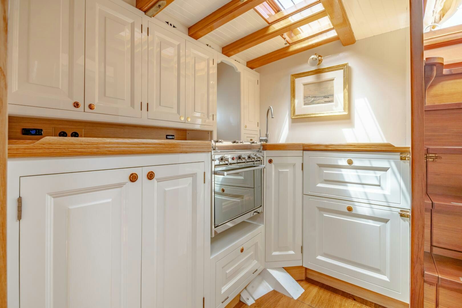 a kitchen with white cabinets aboard ARMIDE Yacht for Sale