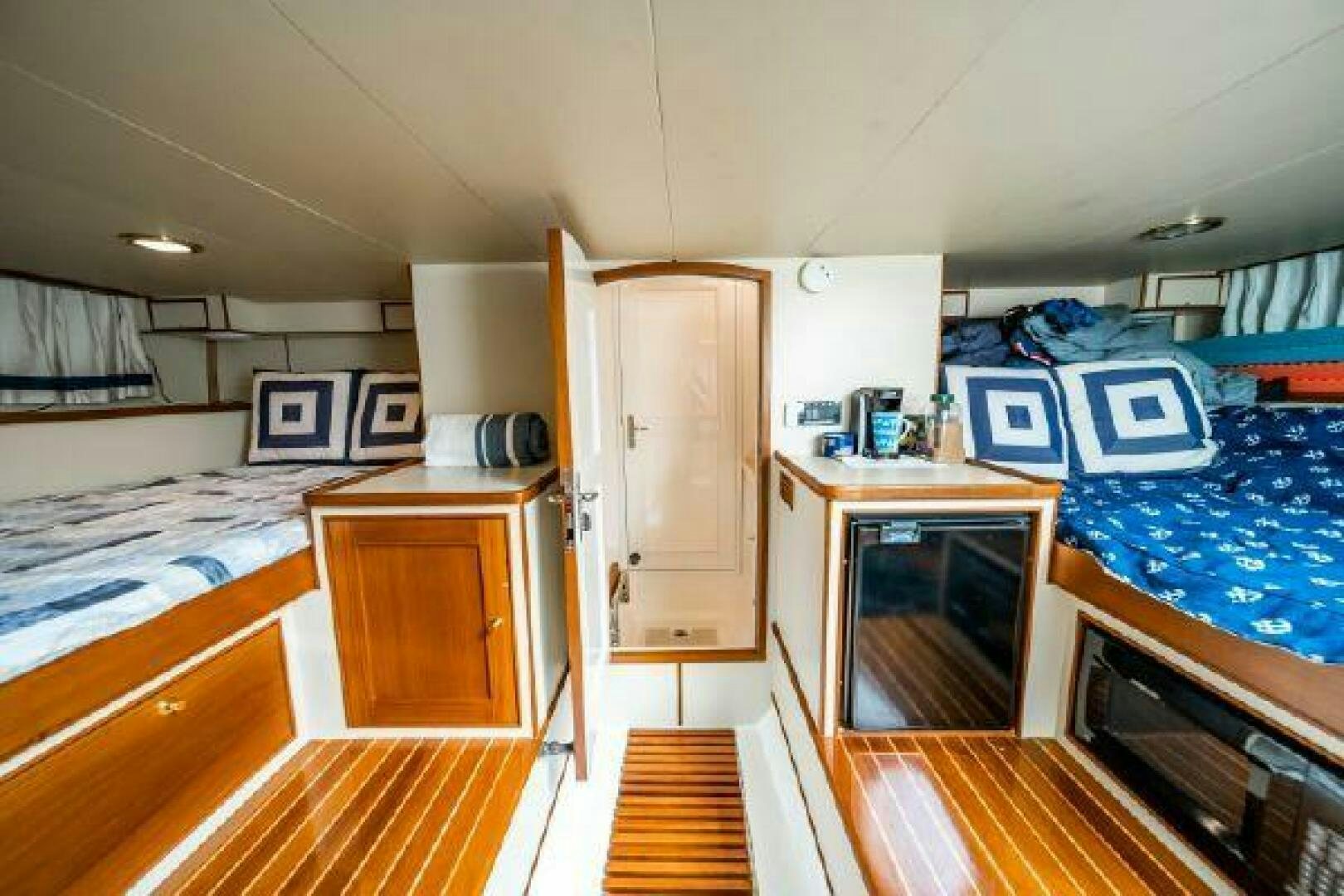 a room with a bed and desk aboard QUARRY Yacht for Sale