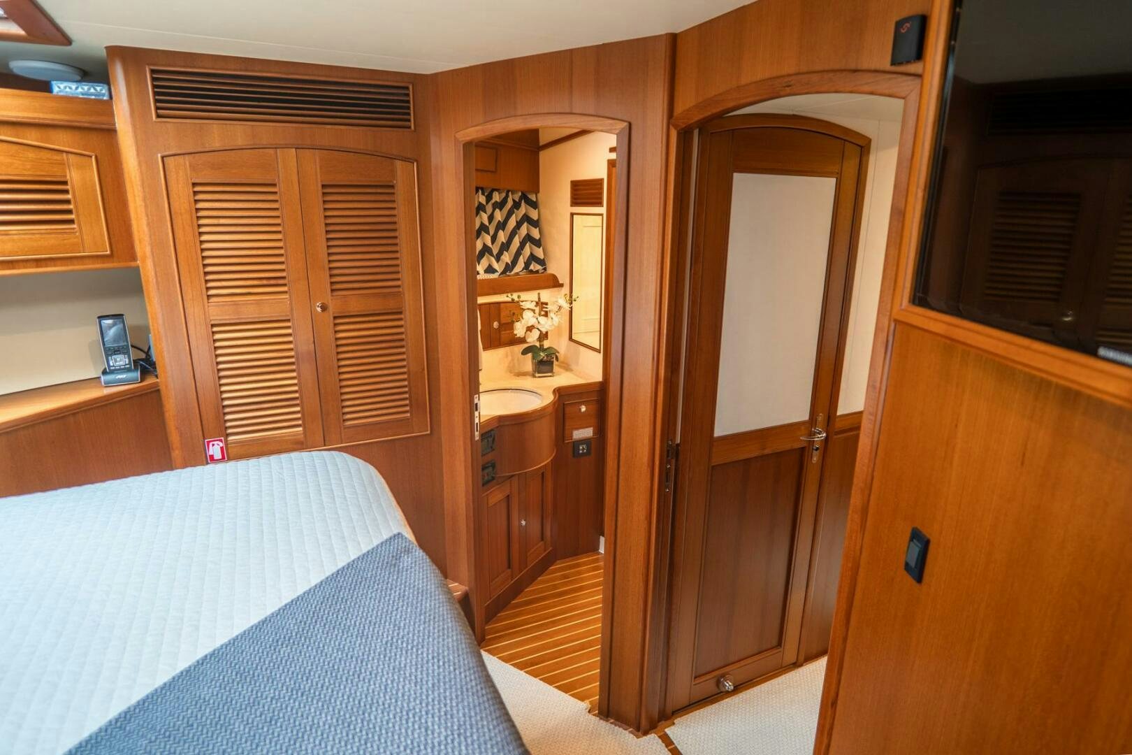 a bedroom with a bed and a closet aboard QUARRY Yacht for Sale
