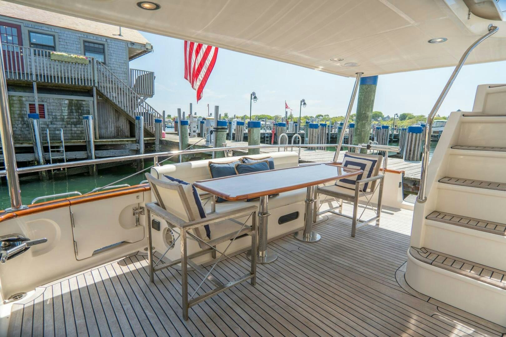 a deck with a table and chairs aboard QUARRY Yacht for Sale