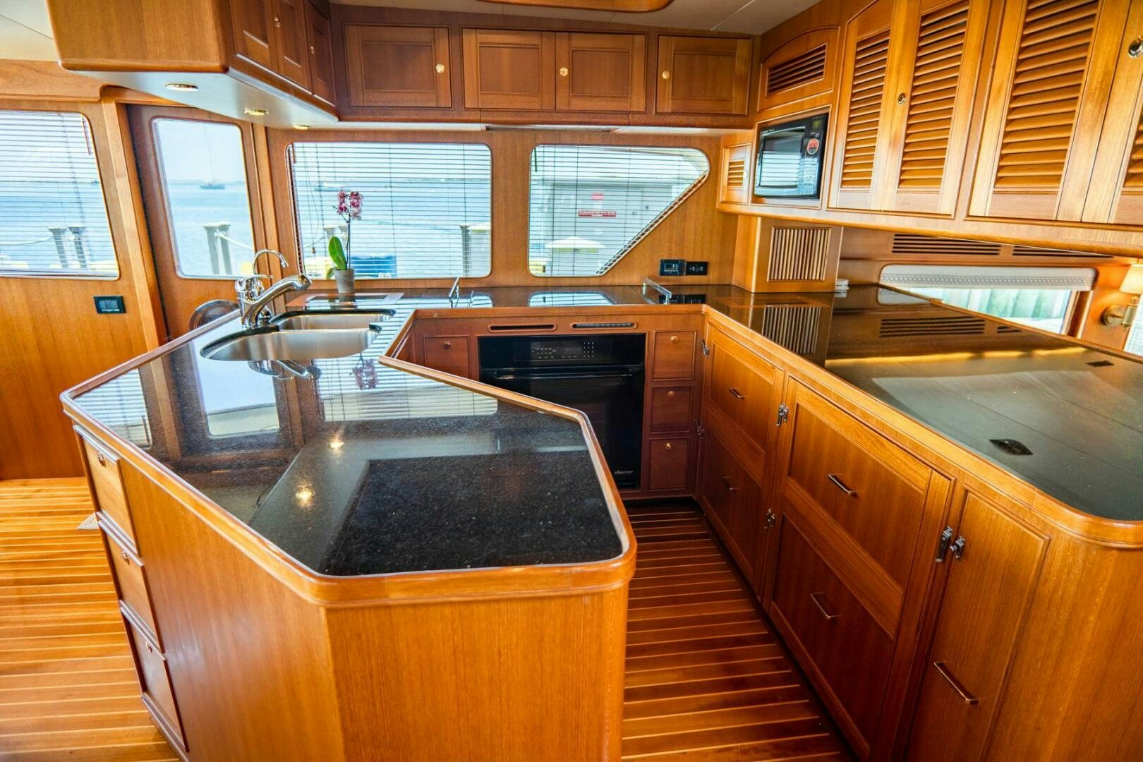 a kitchen with wooden cabinets aboard QUARRY Yacht for Sale