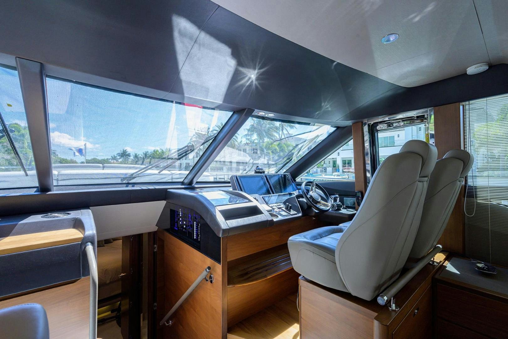 inside of a vehicle with a desk and chairs and a window aboard KHATCH YOU LATER Yacht for Sale