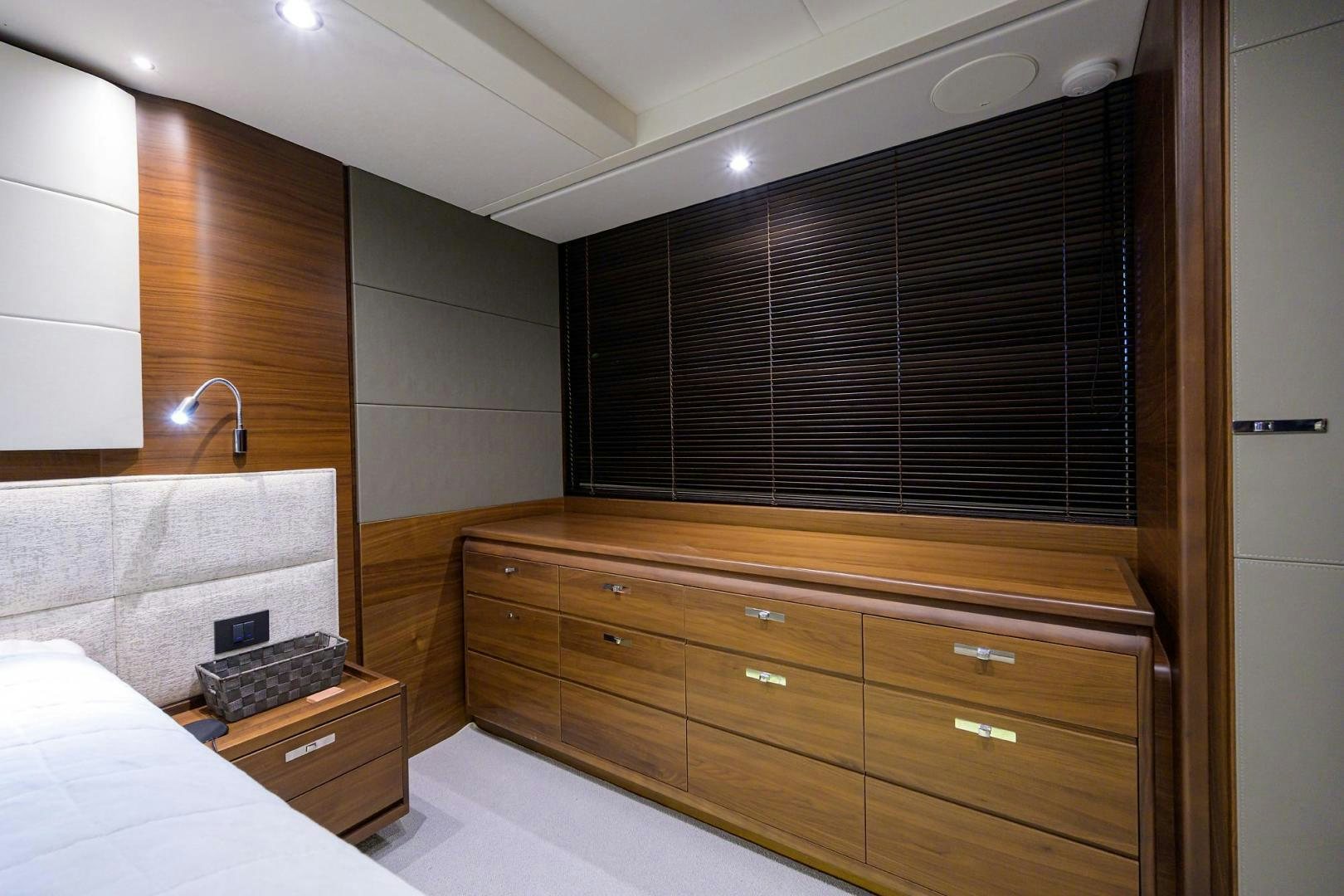 a bathroom with a sink and a bed aboard KHATCH YOU LATER Yacht for Sale