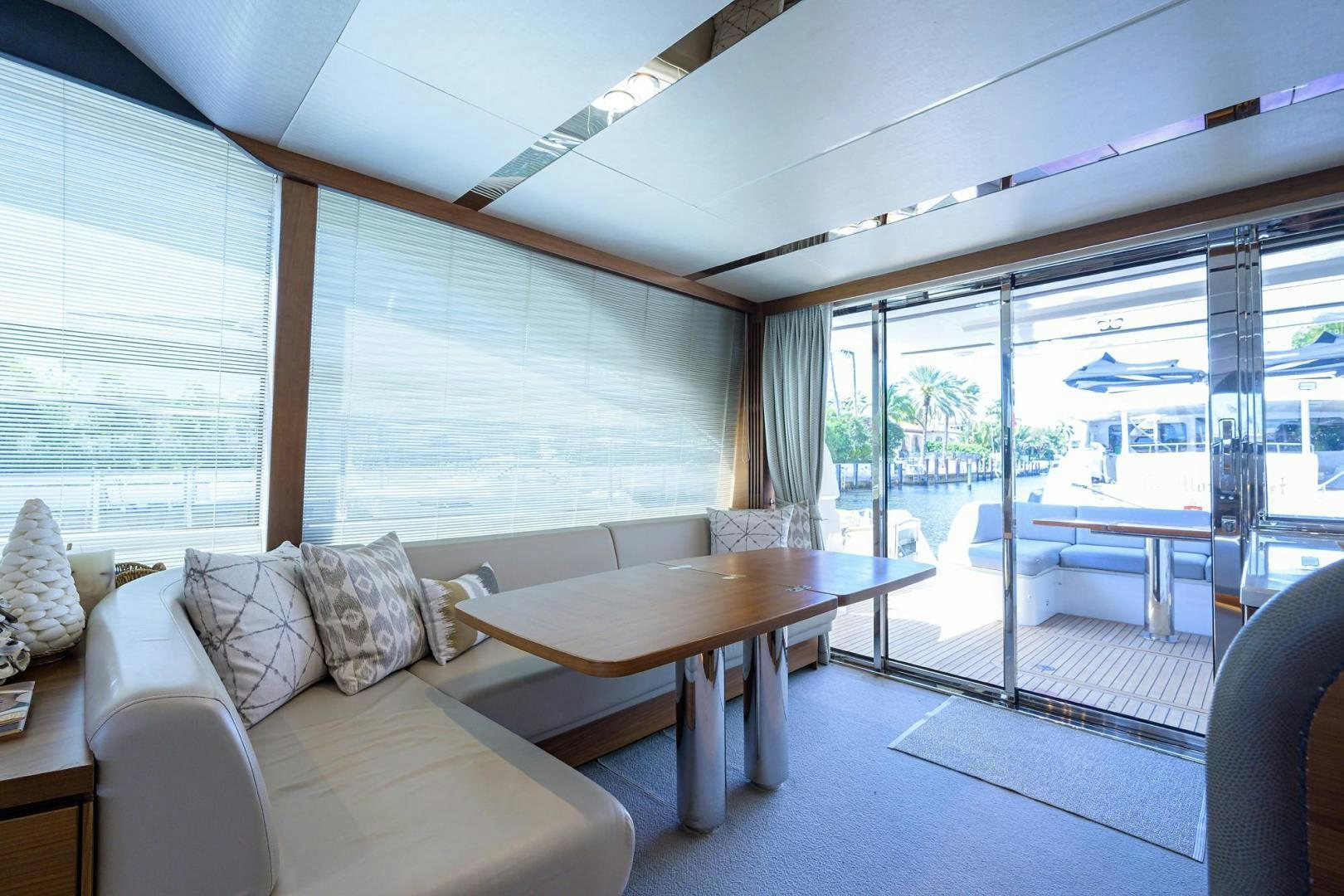 a living room with a table and couches aboard KHATCH YOU LATER Yacht for Sale