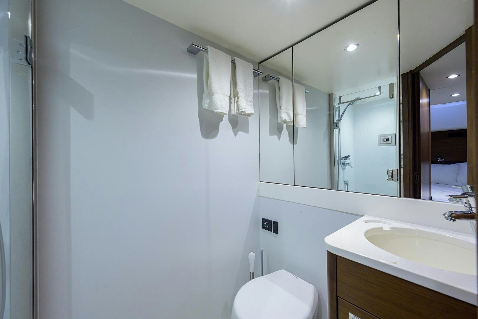 a bathroom with a mirror and a sink aboard KHATCH YOU LATER Yacht for Sale