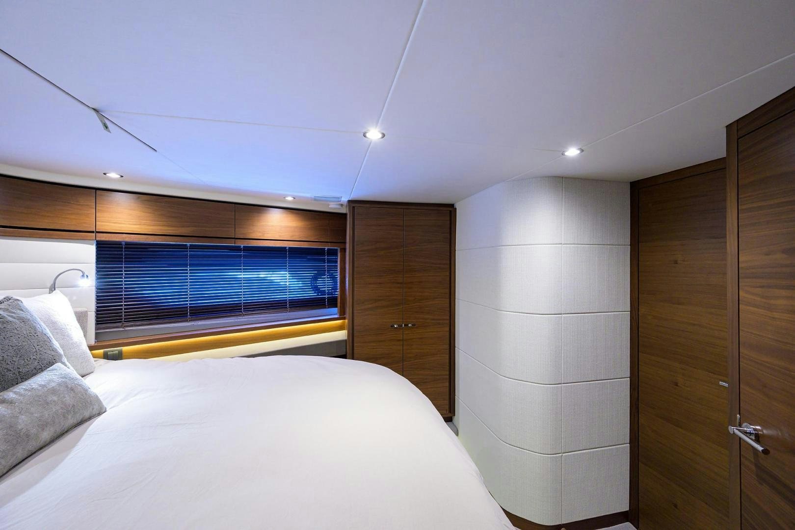 a bedroom with a bed and a closet aboard KHATCH YOU LATER Yacht for Sale