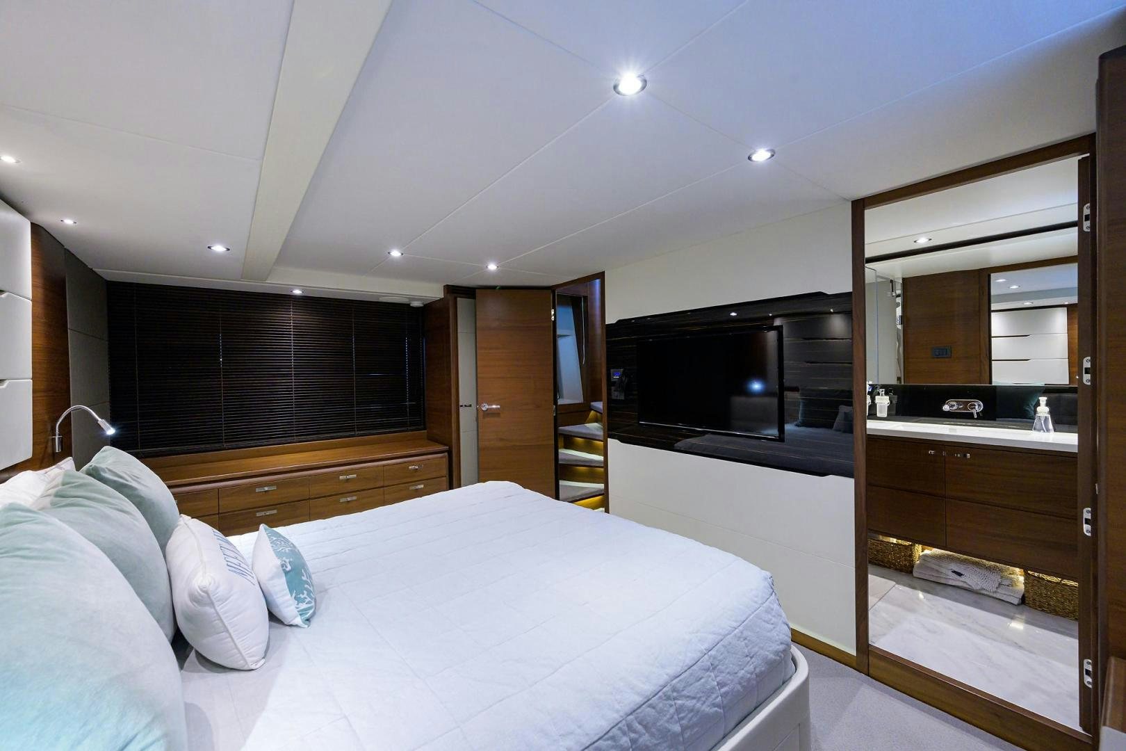 a bedroom with a bed and a closet aboard KHATCH YOU LATER Yacht for Sale