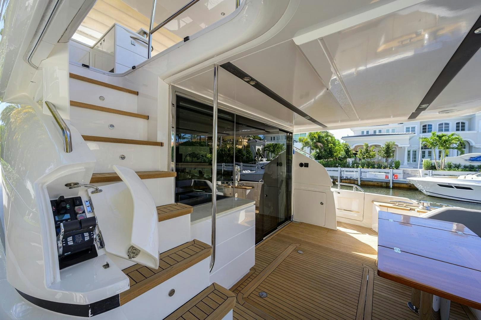 a room with a wood floor and a large glass door aboard KHATCH YOU LATER Yacht for Sale