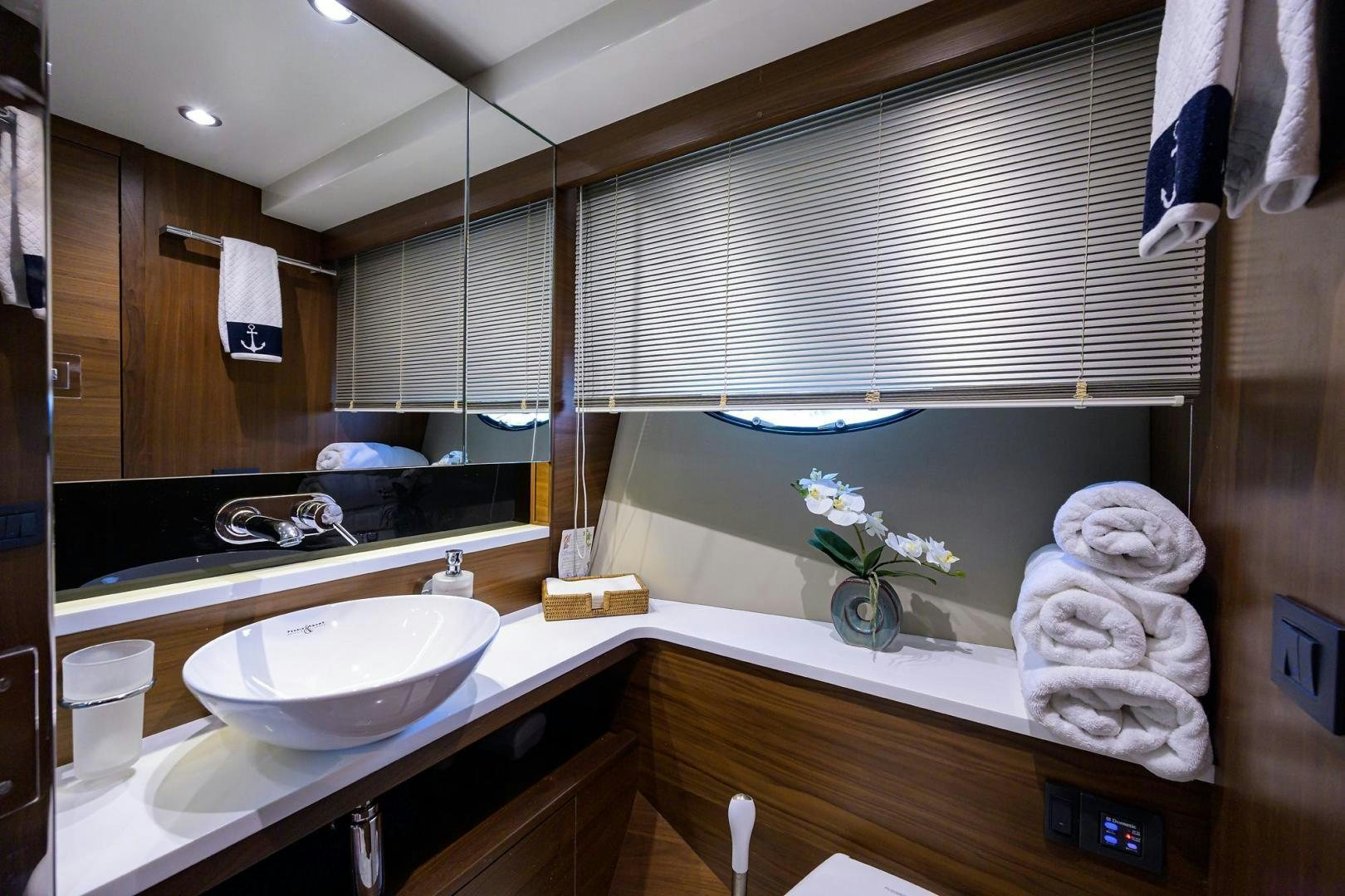 a bathroom with a sink and towels aboard KHATCH YOU LATER Yacht for Sale