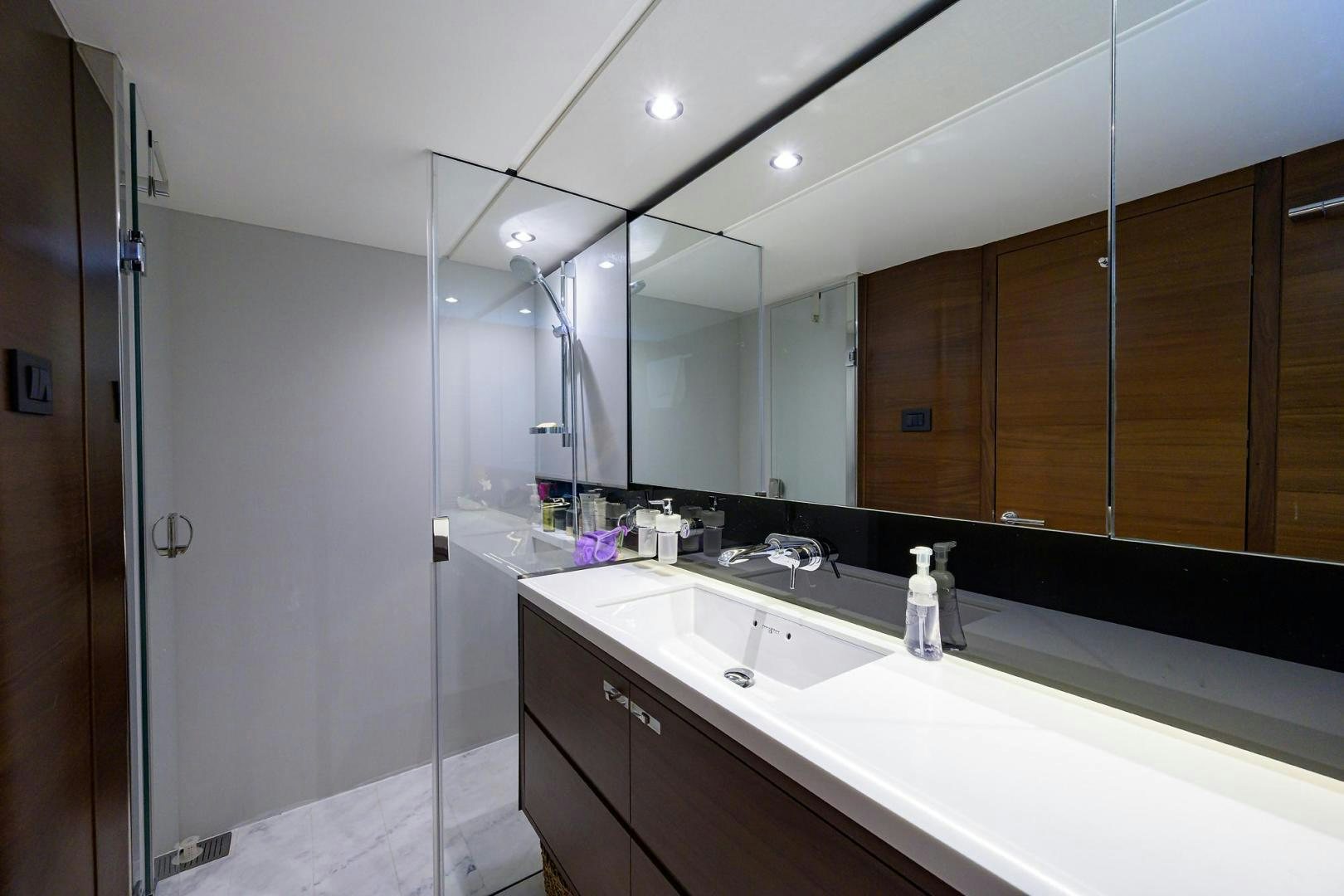 a bathroom with a large mirror aboard KHATCH YOU LATER Yacht for Sale