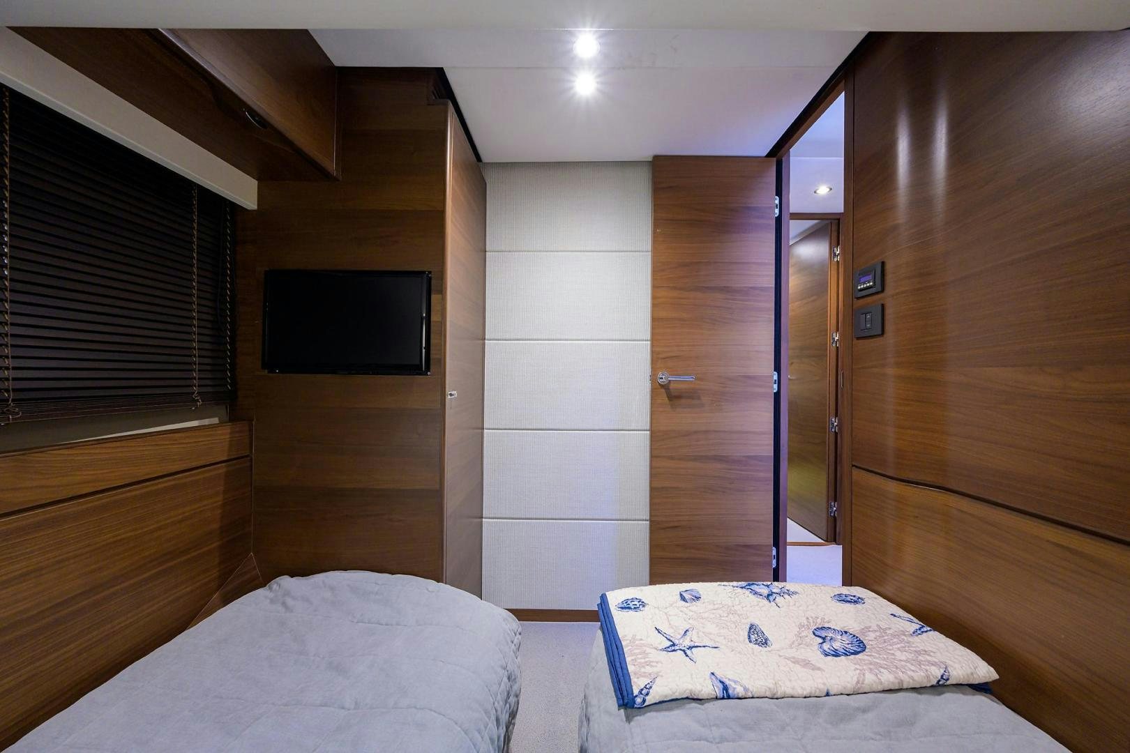 a room with a bed and a television aboard KHATCH YOU LATER Yacht for Sale