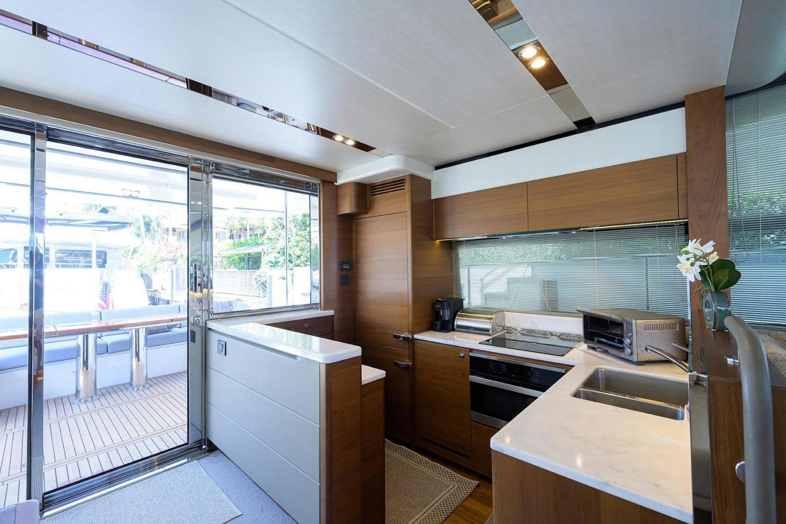 a kitchen with a glass door aboard KHATCH YOU LATER Yacht for Sale