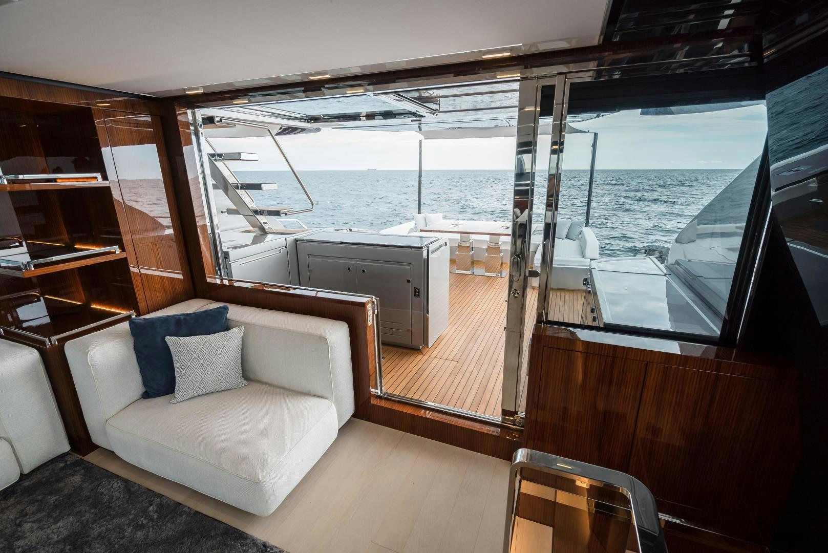 a room with a view of the ocean and a balcony aboard BEL SOGNO Yacht for Sale
