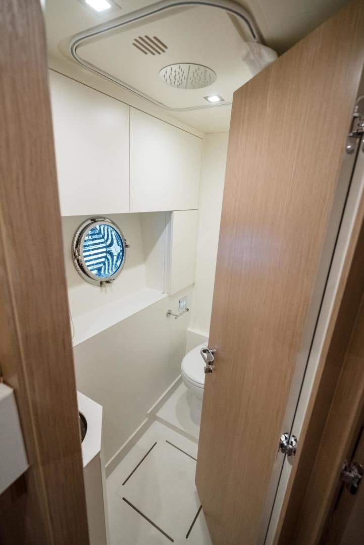 a bathroom with a round mirror aboard BEL SOGNO Yacht for Sale