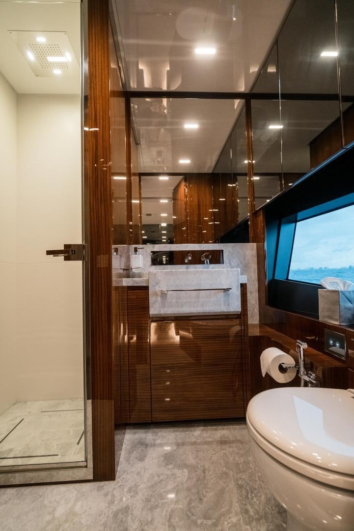 a bathroom with a wood door aboard BEL SOGNO Yacht for Sale