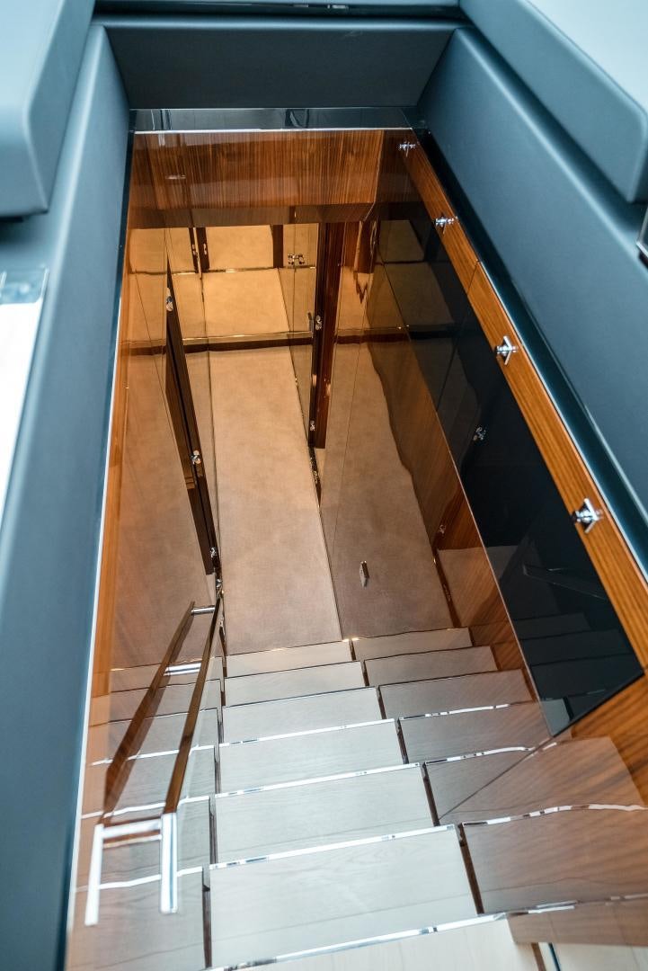 a wooden staircase with a wood railing aboard BEL SOGNO Yacht for Sale