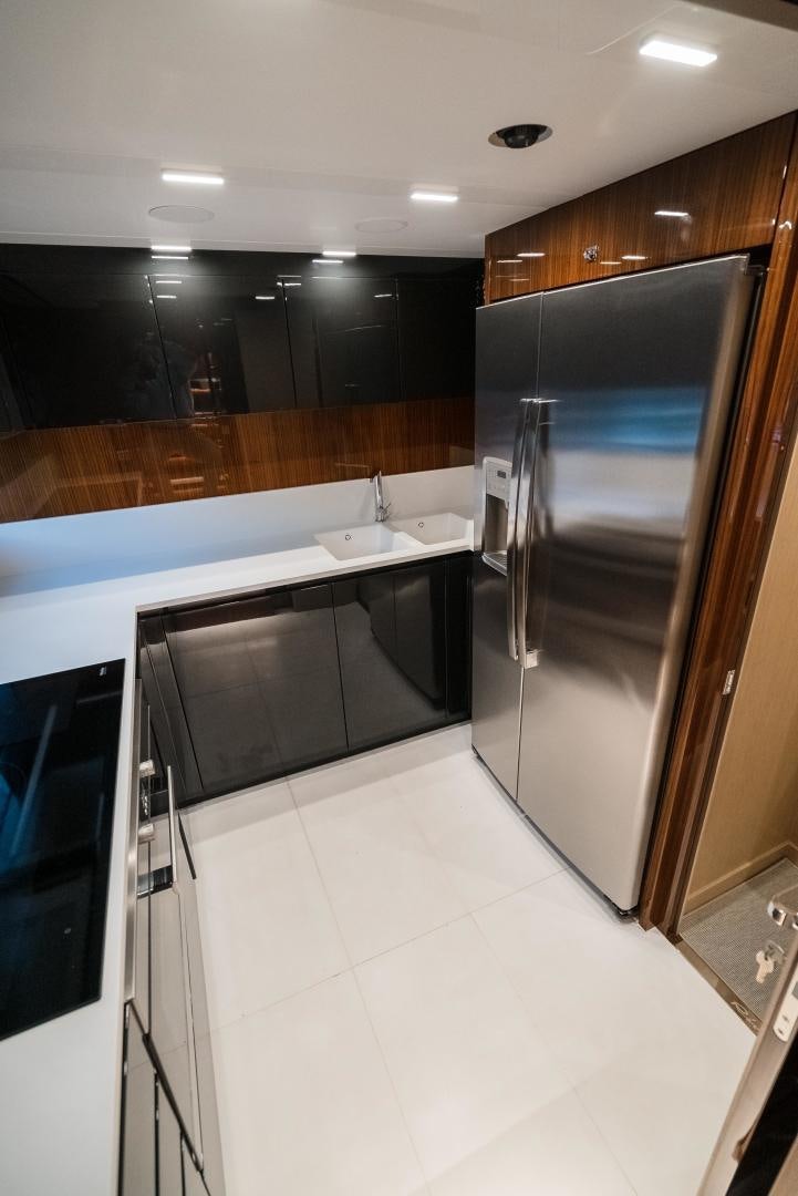 a kitchen with a stainless steel refrigerator aboard BEL SOGNO Yacht for Sale