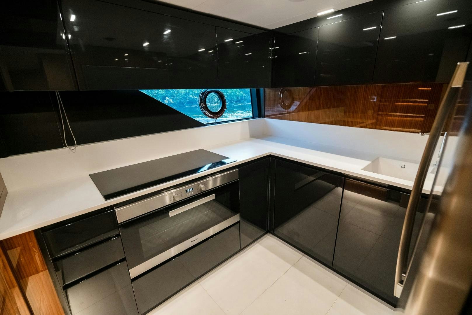 a large kitchen with black counter tops aboard BEL SOGNO Yacht for Sale