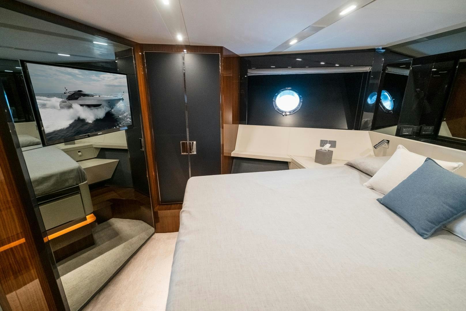 a room with a bed and a television aboard BEL SOGNO Yacht for Sale