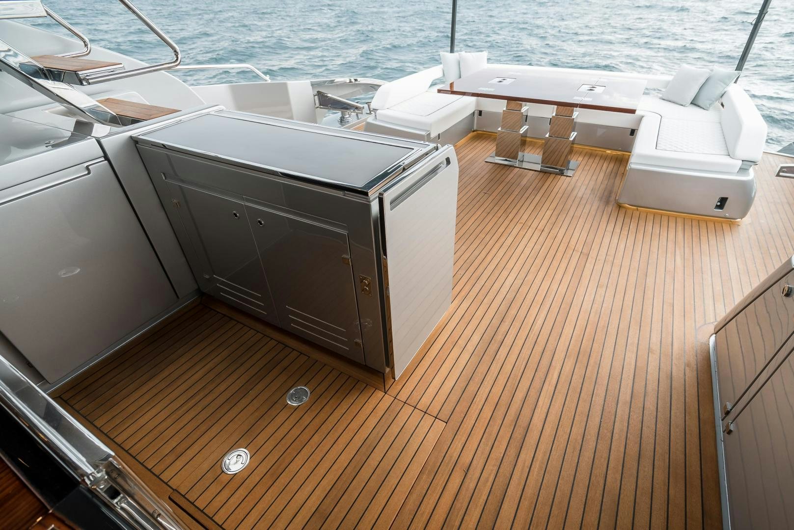 a deck with a deck and a large sink and a table with chairs aboard BEL SOGNO Yacht for Sale