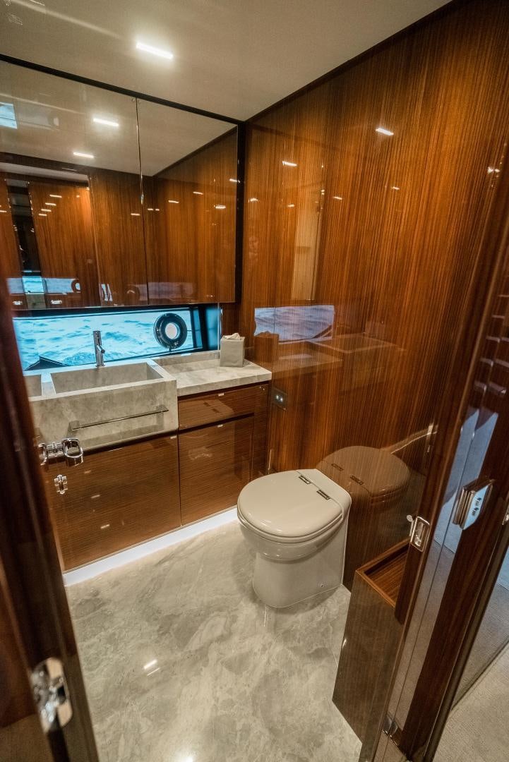 a bathroom with a toilet and a sink aboard BEL SOGNO Yacht for Sale