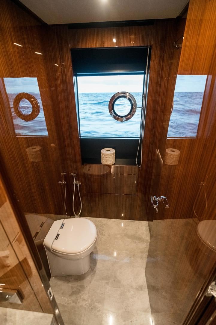 a bathroom with a large window aboard BEL SOGNO Yacht for Sale