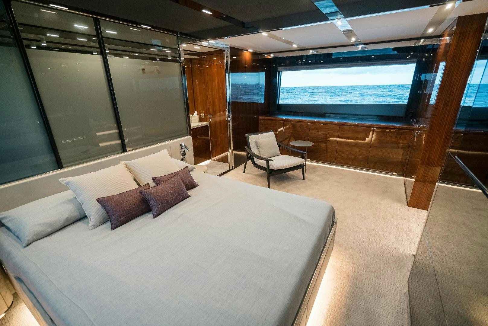 a room with a bed and a large window aboard BEL SOGNO Yacht for Sale