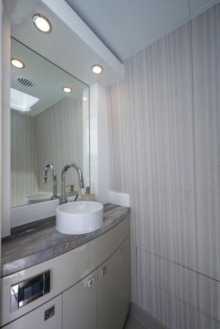 a bathroom with a sink and a mirror aboard CONGVOYAGE Yacht for Sale