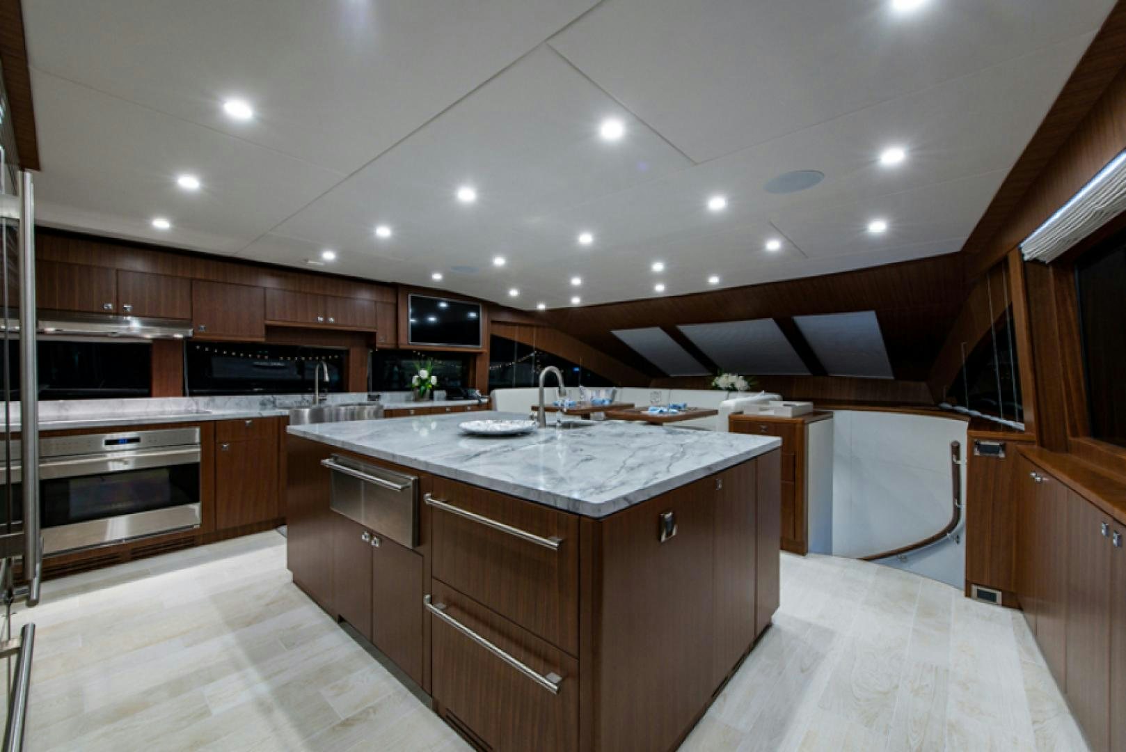 a large kitchen with wooden cabinets aboard CONGVOYAGE Yacht for Sale