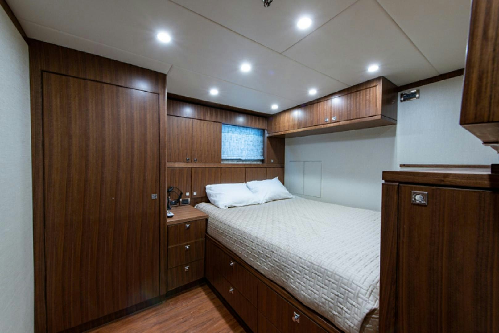 a bedroom with a bed and a closet aboard CONGVOYAGE Yacht for Sale