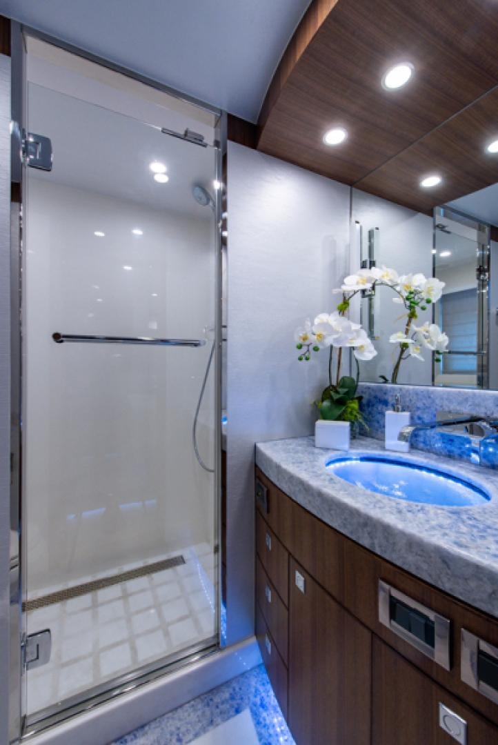 a bathroom with a shower and sink aboard CONGVOYAGE Yacht for Sale