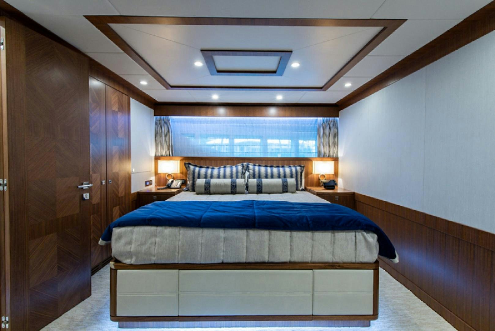 a bedroom with a bed and a desk aboard CONGVOYAGE Yacht for Sale