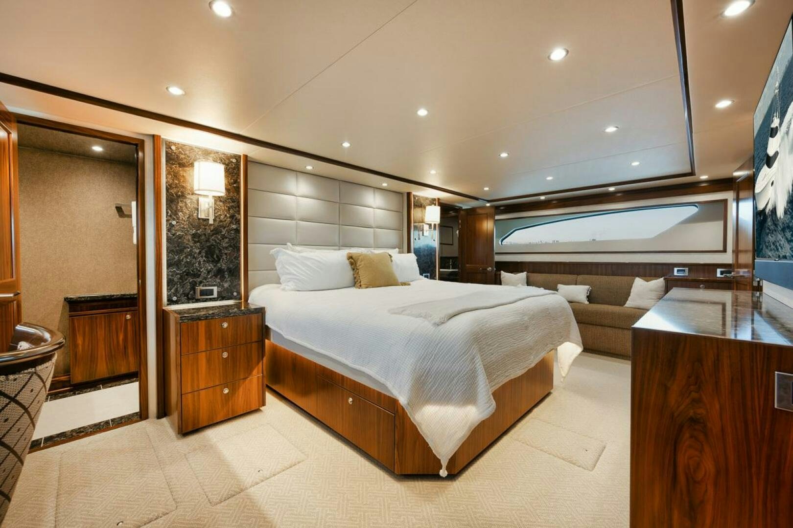 a large hotel room with a large bed and a large mirror aboard FA-LA-ME Yacht for Sale