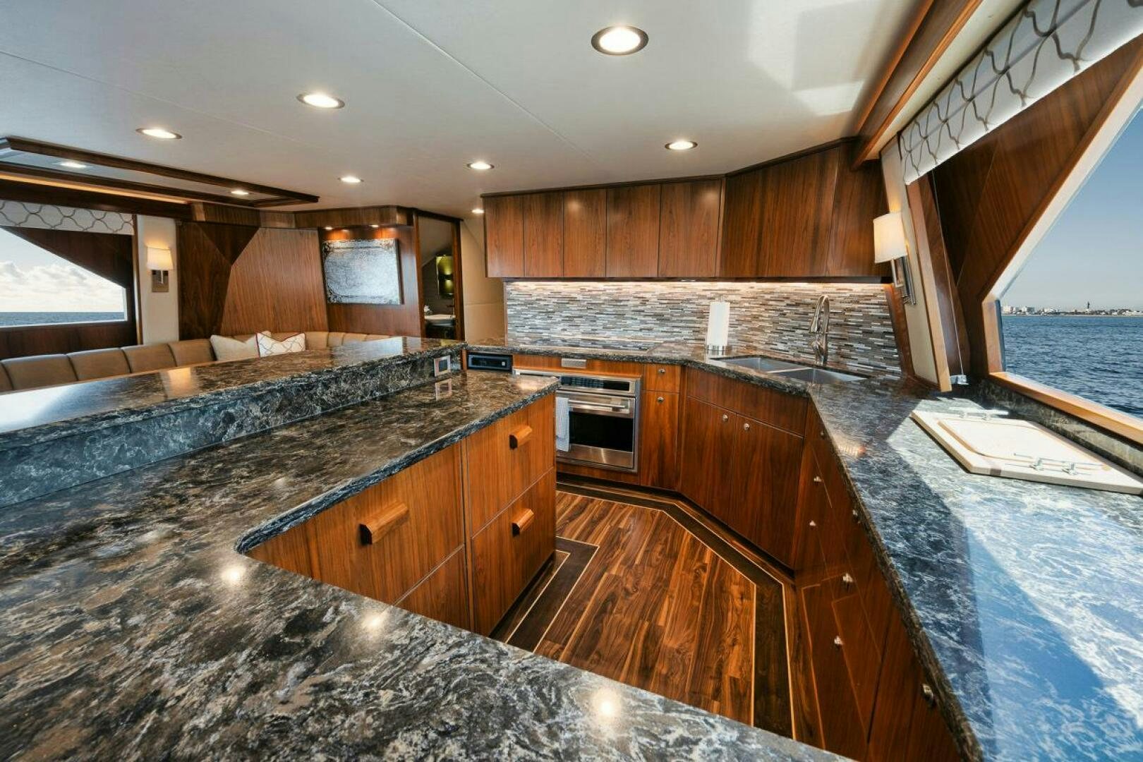 a large kitchen with wooden cabinets aboard FA-LA-ME Yacht for Sale