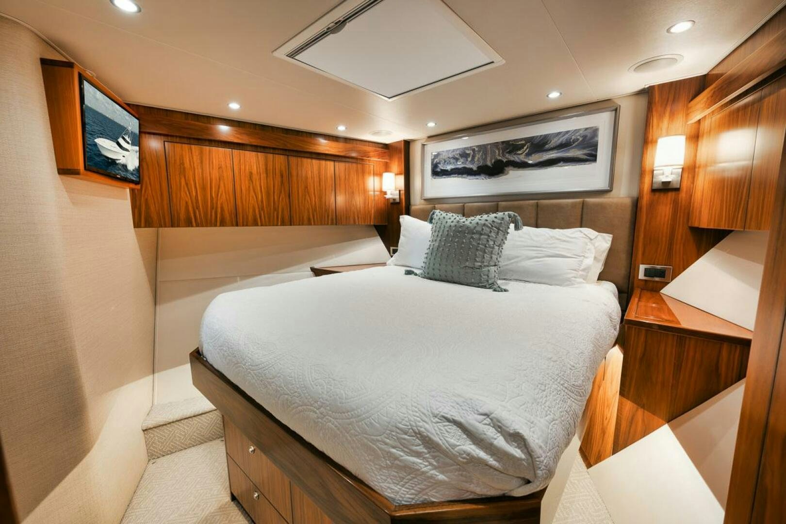 a room with a bed and a television aboard FA-LA-ME Yacht for Sale